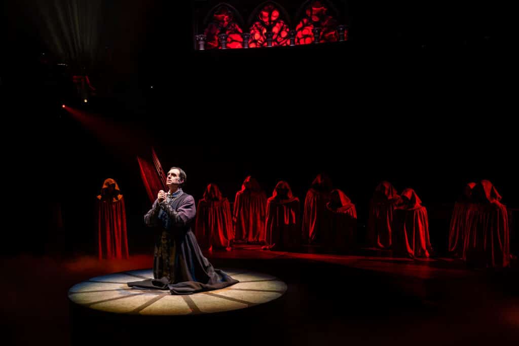 Josh Richardson as Claude Frollo, praying to Mary for guidance and protection.